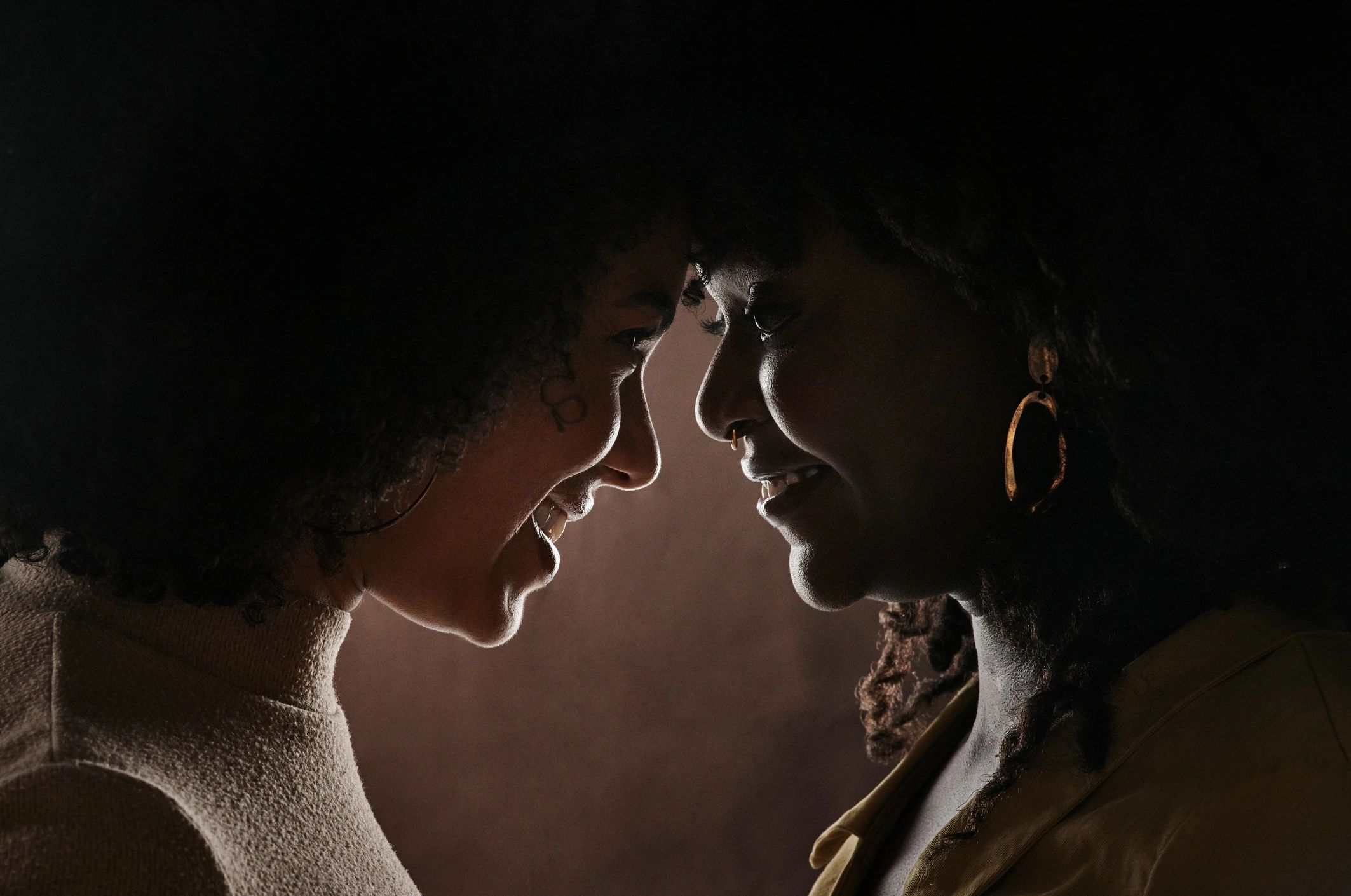 Two women portrait in warm studio light