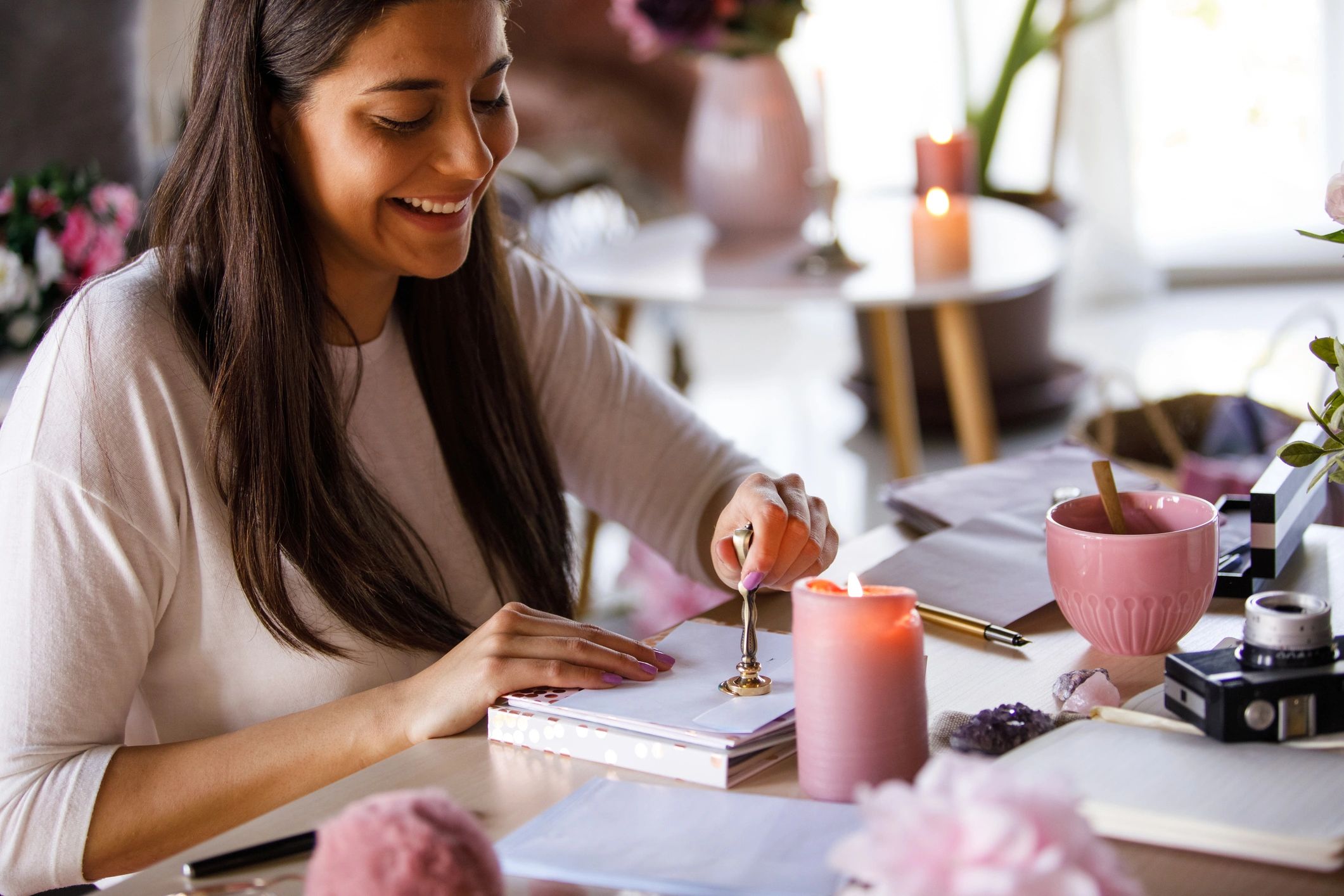 Hands sealing an envelope with wax