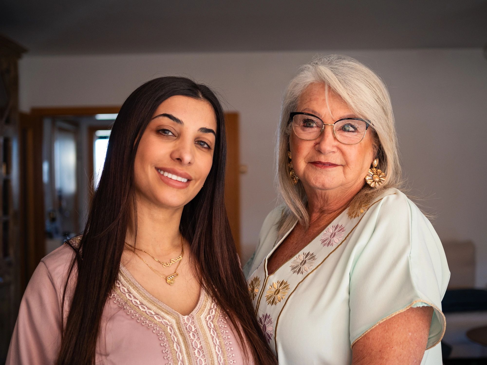 Two women posing together at a gathering