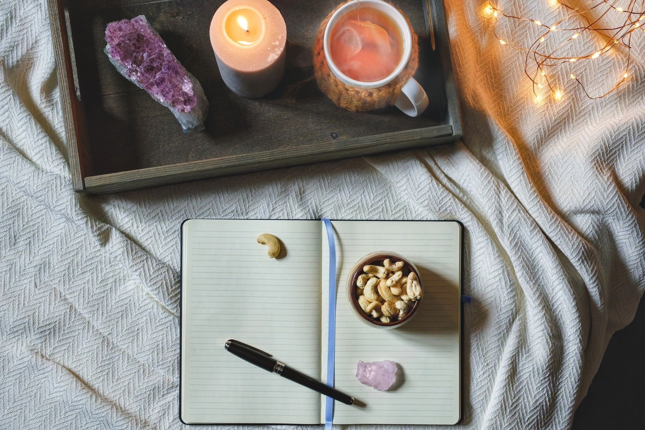 Cozy journaling scene with candlelight and tea, evoking a calm sanctuary