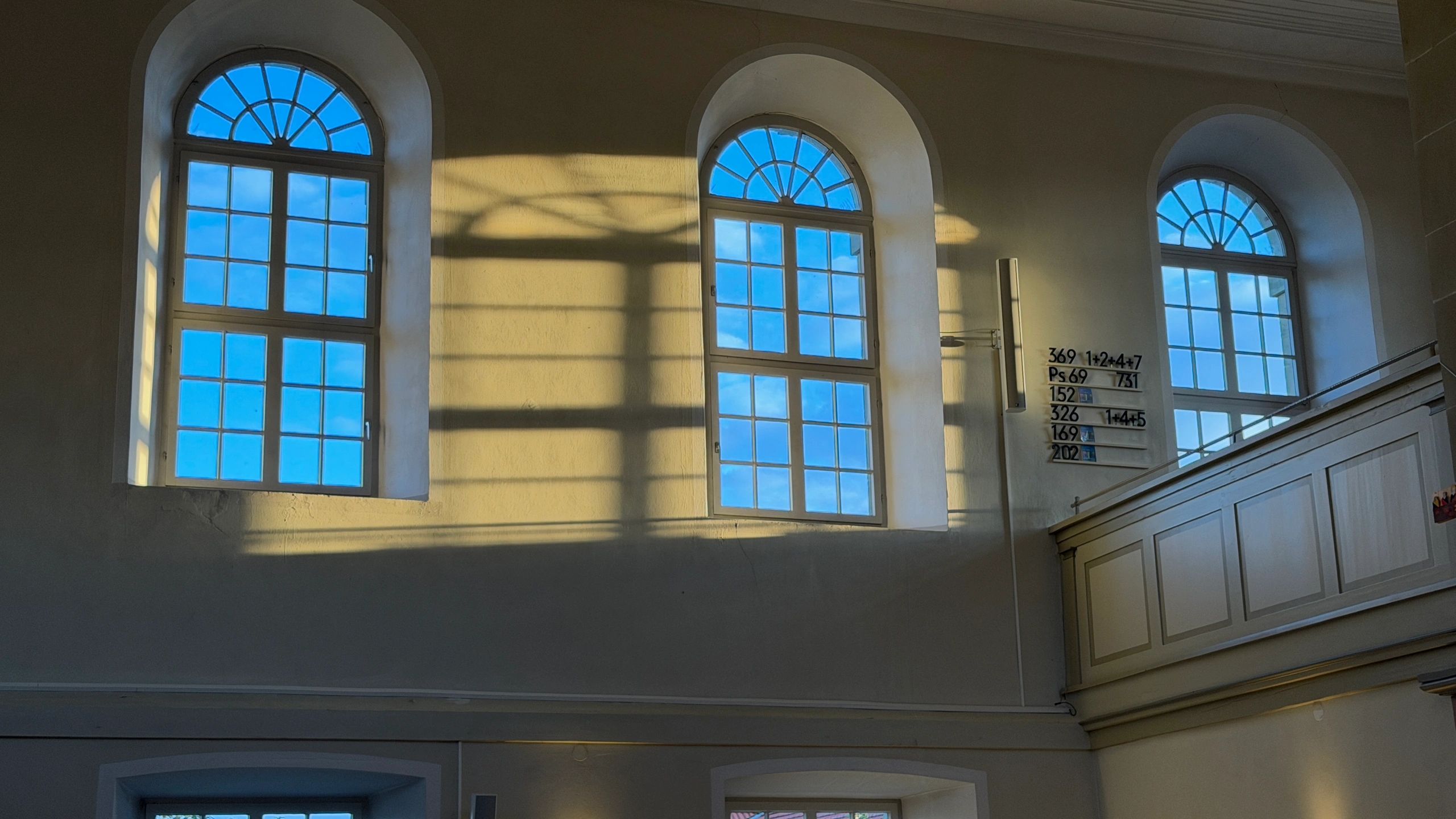 Soft light through tall windows in a quiet interior