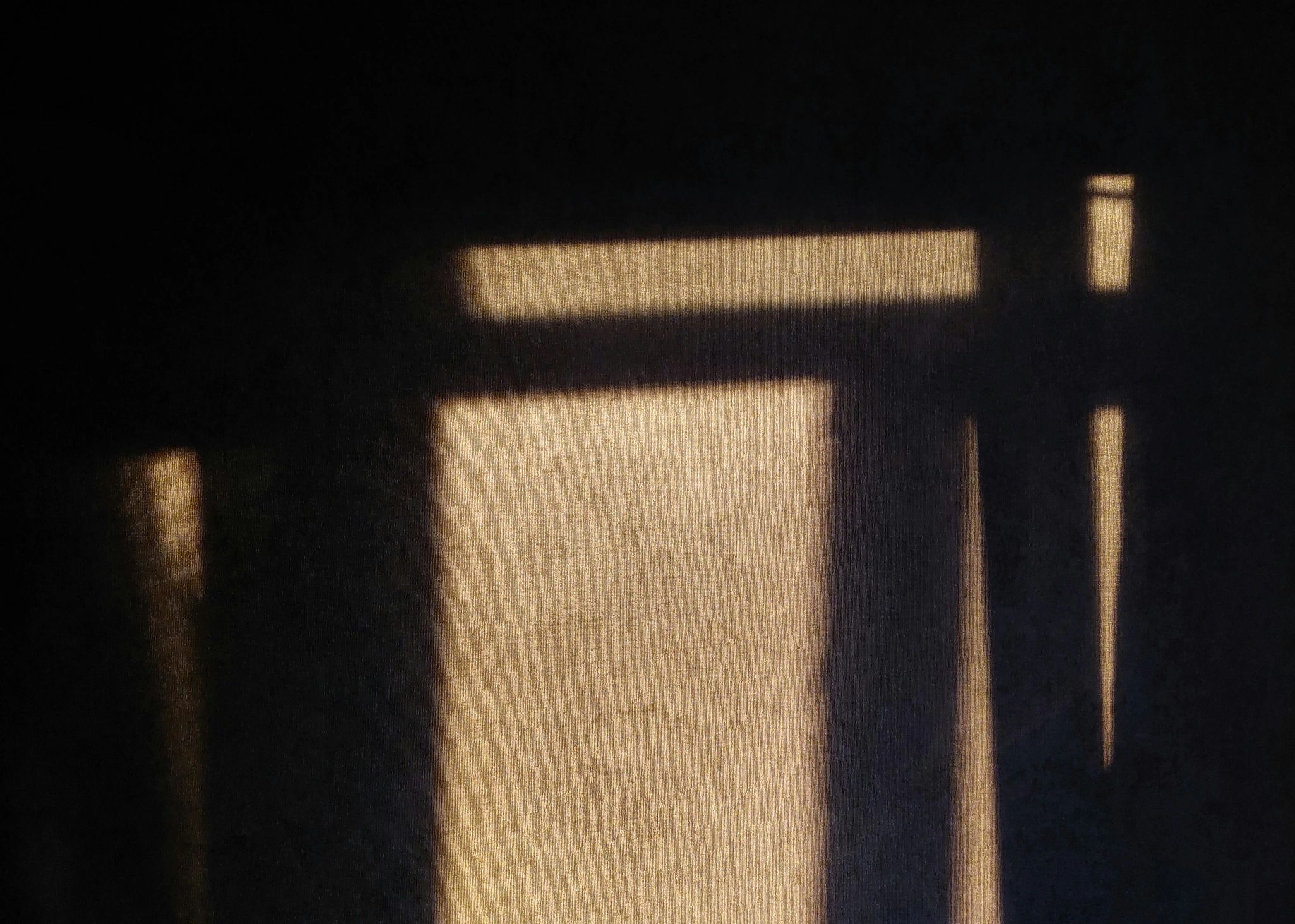 Warm sunlight casting geometric shadows on a textured wall, symbolizing calm and clarity