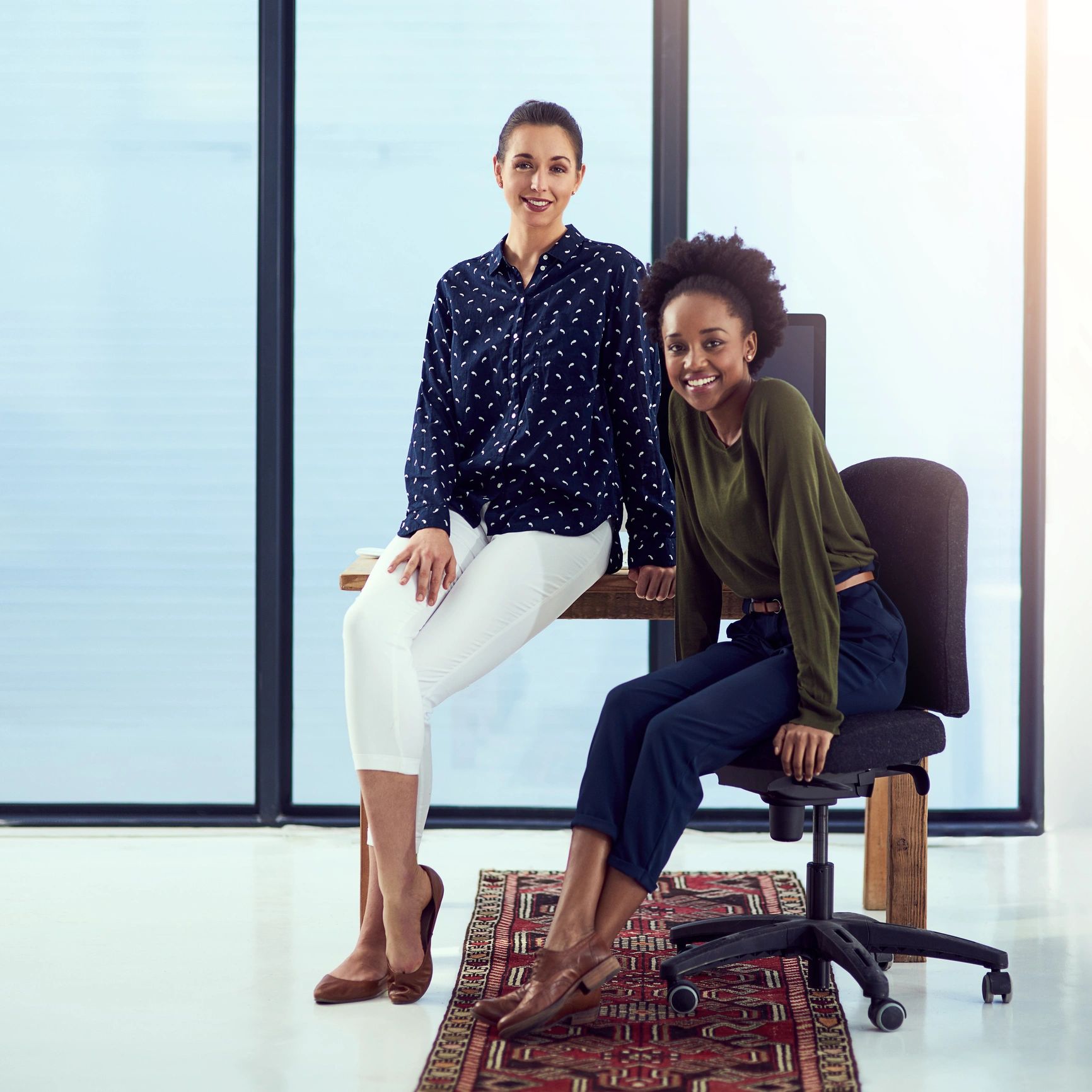 Two women collaborating at a workstation