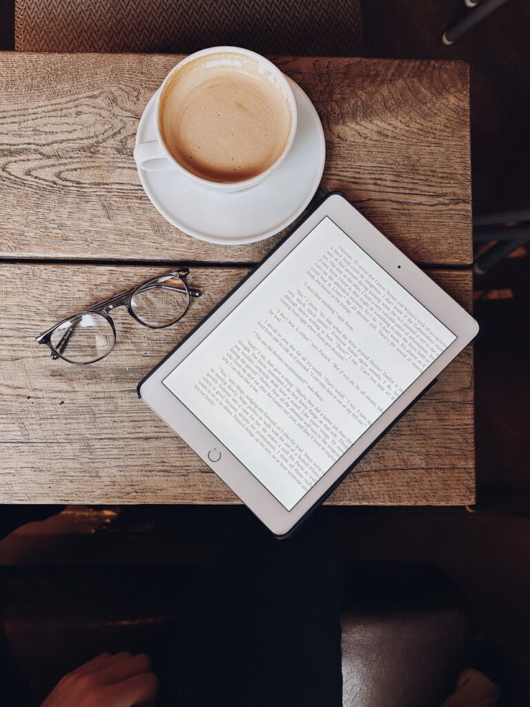 coffee and tablet on a wooden table